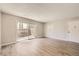 This light and airy living room features wood floors, a sliding glass door and neutral paint tones at 12143 Melody Dr # 104, Denver, CO 80234