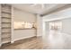 Bright living room features modern wood floors, an open layout, and sliding glass doors to the exterior patio at 12143 Melody Dr # 104, Denver, CO 80234