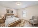 Bright main bedroom featuring neutral decor, wood accents, and a large window at 12143 Melody Dr # 104, Denver, CO 80234