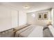 Bright main bedroom featuring neutral decor, wood accents, and a large closet at 12143 Melody Dr # 104, Denver, CO 80234