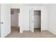 Bedroom featuring 2 doorways, a walk in closet, and neutral colored carpet at 27424 E Byers Ave, Aurora, CO 80018