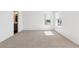 Bright, empty bedroom with carpeted floors, large windows with blinds, and natural light at 27424 E Byers Ave, Aurora, CO 80018