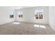 Bright bedroom with carpeted floors, large windows with blinds, and lots of natural light at 27424 E Byers Ave, Aurora, CO 80018