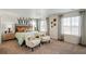 Staged primary bedroom featuring modern decor, neutral colors, carpeted floors, and natural light at 27424 E Byers Ave, Aurora, CO 80018