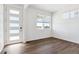 Well-lit room with white walls, modern door, window and wood-look floors at 27424 E Byers Ave, Aurora, CO 80018