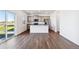 Modern kitchen featuring gray cabinets, stainless steel appliances, and hardwood floors at 27424 E Byers Ave, Aurora, CO 80018