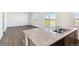 Open floor plan features a kitchen with granite counters, stainless steel sink, and views of the adjacent living space at 27424 E Byers Ave, Aurora, CO 80018
