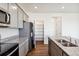 Modern kitchen features granite counters, stainless appliances, and a pantry for ample storage space at 27424 E Byers Ave, Aurora, CO 80018