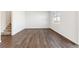 Spacious room with staircase, hardwood floors, large window allowing natural light and backyard view at 27424 E Byers Ave, Aurora, CO 80018