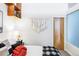 Bedroom with a bed, wall hanging, and a wood door at 7700 E 29Th Ave # 411, Denver, CO 80238