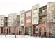 Brick building exterior with snow-covered landscaping at 7700 E 29Th Ave # 411, Denver, CO 80238