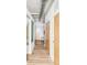 Bright hallway with modern design featuring hardwood floors and exposed ductwork at 7700 E 29Th Ave # 411, Denver, CO 80238