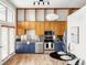 Modern kitchen with stainless steel appliances, bright lighting, and open dining area at 7700 E 29Th Ave # 411, Denver, CO 80238