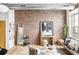 Open living space with brick accent wall, stylish decor, and plenty of natural light at 7700 E 29Th Ave # 411, Denver, CO 80238