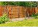 Backyard garden with a wooden fence featuring a charming trellis and lush greenery, creating a serene outdoor retreat at 1410 S Ammons St, Lakewood, CO 80232