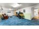 Spacious finished basement featuring an office area, a couch, and carpeted floors at 1410 S Ammons St, Lakewood, CO 80232