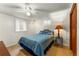 Cozy bedroom with a ceiling fan, window, and comfortable-looking bed at 1410 S Ammons St, Lakewood, CO 80232