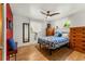 Bedroom featuring hardwood floors, two dressers, and a blue and white quilt bedspread at 1410 S Ammons St, Lakewood, CO 80232