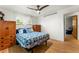Cozy bedroom with hardwood floors, comfortable bed, and plenty of natural light at 1410 S Ammons St, Lakewood, CO 80232