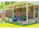 Charming covered patio with furniture, decor, and access to a lush backyard at 1410 S Ammons St, Lakewood, CO 80232