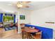 Cozy dining area featuring a ceiling fan, wood table, and an adjacent living room with bright natural light at 1410 S Ammons St, Lakewood, CO 80232