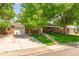 A beautiful single-story brick home with an attached garage, driveway, and well-manicured lawn at 1410 S Ammons St, Lakewood, CO 80232