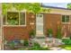 Charming brick facade with decorative planters flanking the entrance of this lovely home at 1410 S Ammons St, Lakewood, CO 80232