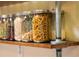 Features a spice rack with spice jars, decorative and industrial-style shelving at 1410 S Ammons St, Lakewood, CO 80232