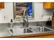 Close up of stainless steel sink and faucet with ample counter space at 1410 S Ammons St, Lakewood, CO 80232