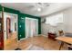 Office space featuring hardwood floors, closet, natural light, and green accent wall at 1410 S Ammons St, Lakewood, CO 80232