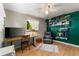 Bright and airy office space with hardwood floors, ample shelving, and a comfortable leather chair at 1410 S Ammons St, Lakewood, CO 80232