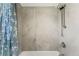 Sleek shower with shower curtain and adjustable shower head at 1410 S Ammons St, Lakewood, CO 80232