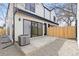 Backyard featuring an AC unit, wood fence, concrete and rock at 3047 S Cherokee St, Englewood, CO 80110