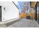 Backyard featuring an AC unit, wood fence, concrete and rock at 3047 S Cherokee St, Englewood, CO 80110