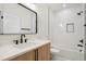 Modern bathroom with a white marble vanity, a black faucet, and a black-trimmed mirror at 3047 S Cherokee St, Englewood, CO 80110