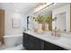 Bathroom features a double vanity, soaking tub, large mirror, and modern fixtures at 3047 S Cherokee St, Englewood, CO 80110