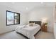Bright bedroom features a large window, neutral walls, and a comfortable bed with stylish bedding at 3047 S Cherokee St, Englewood, CO 80110