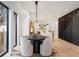 Bright dining area with modern furnishings, adjacent to the staircase and kitchen with hardwood floors at 3047 S Cherokee St, Englewood, CO 80110