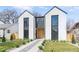 Modern two-story home with light exterior, black trim, rock pathway, and minimalist landscaping at 3047 S Cherokee St, Englewood, CO 80110