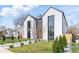 Modern two-story home with light exterior, black trim, rock pathway, and minimalist landscaping at 3047 S Cherokee St, Englewood, CO 80110