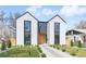 Modern two-story home with light exterior, black trim, rock pathway, and minimalist landscaping at 3047 S Cherokee St, Englewood, CO 80110
