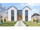 Modern two-story home with light exterior, black trim, rock pathway, and minimalist landscaping at 3047 S Cherokee St, Englewood, CO 80110
