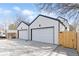 Two-car attached garages with modern doors and black trim, offering convenient parking and storage at 3047 S Cherokee St, Englewood, CO 80110