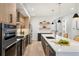 Bright kitchen featuring stainless steel appliances, light wood floors and modern cabinetry and a kitchen island at 3047 S Cherokee St, Englewood, CO 80110