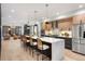 Open-concept kitchen with quartz island, pendant lighting, hardwood floors, and stainless steel appliances at 3047 S Cherokee St, Englewood, CO 80110