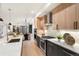 Kitchen featuring quartz island, modern appliances, and view of open concept dining and living spaces at 3047 S Cherokee St, Englewood, CO 80110
