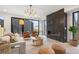 Bright living room featuring a fireplace, modern furnishings and access to backyard through sliding glass door at 3047 S Cherokee St, Englewood, CO 80110