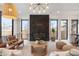 Bright living room featuring a stone fireplace, modern furnishings, hardwood floors and a large window at 3047 S Cherokee St, Englewood, CO 80110