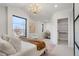 Bright, spacious bedroom featuring a walk-in closet and a view of the neighborhood at 3047 S Cherokee St, Englewood, CO 80110