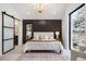Spacious bedroom featuring accent wall, slider to ensuite, chandelier, and large windows at 3047 S Cherokee St, Englewood, CO 80110